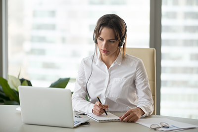 Woman At Laptop With Headphones